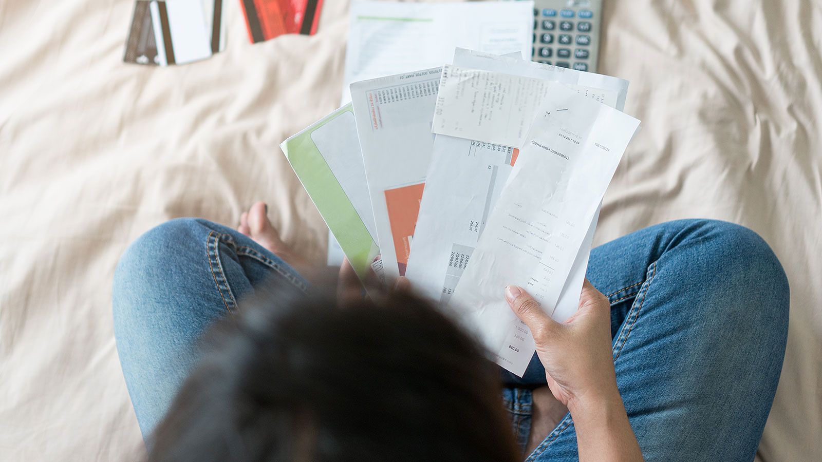 A person holding credit cards, representing credit card consolidation