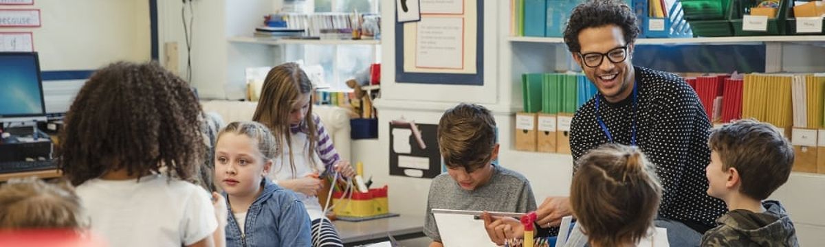 Elementary teacher laughing with students