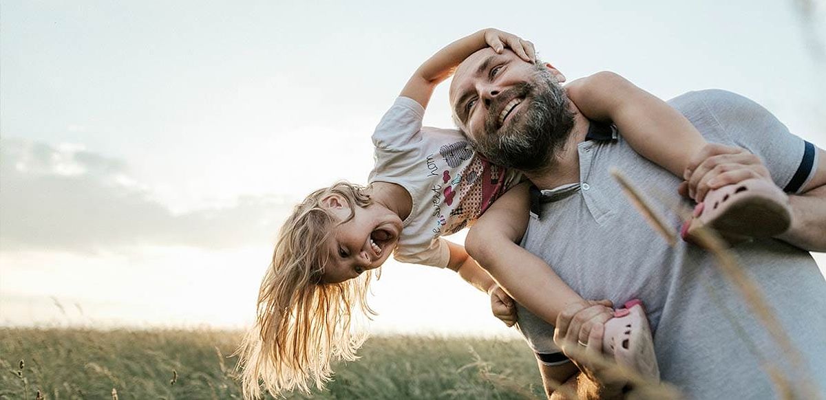 Man with daughter playing outside